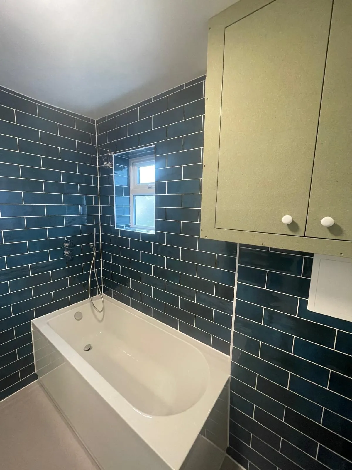 Commercial bathroom egham after teal tiles bath by Trade Square