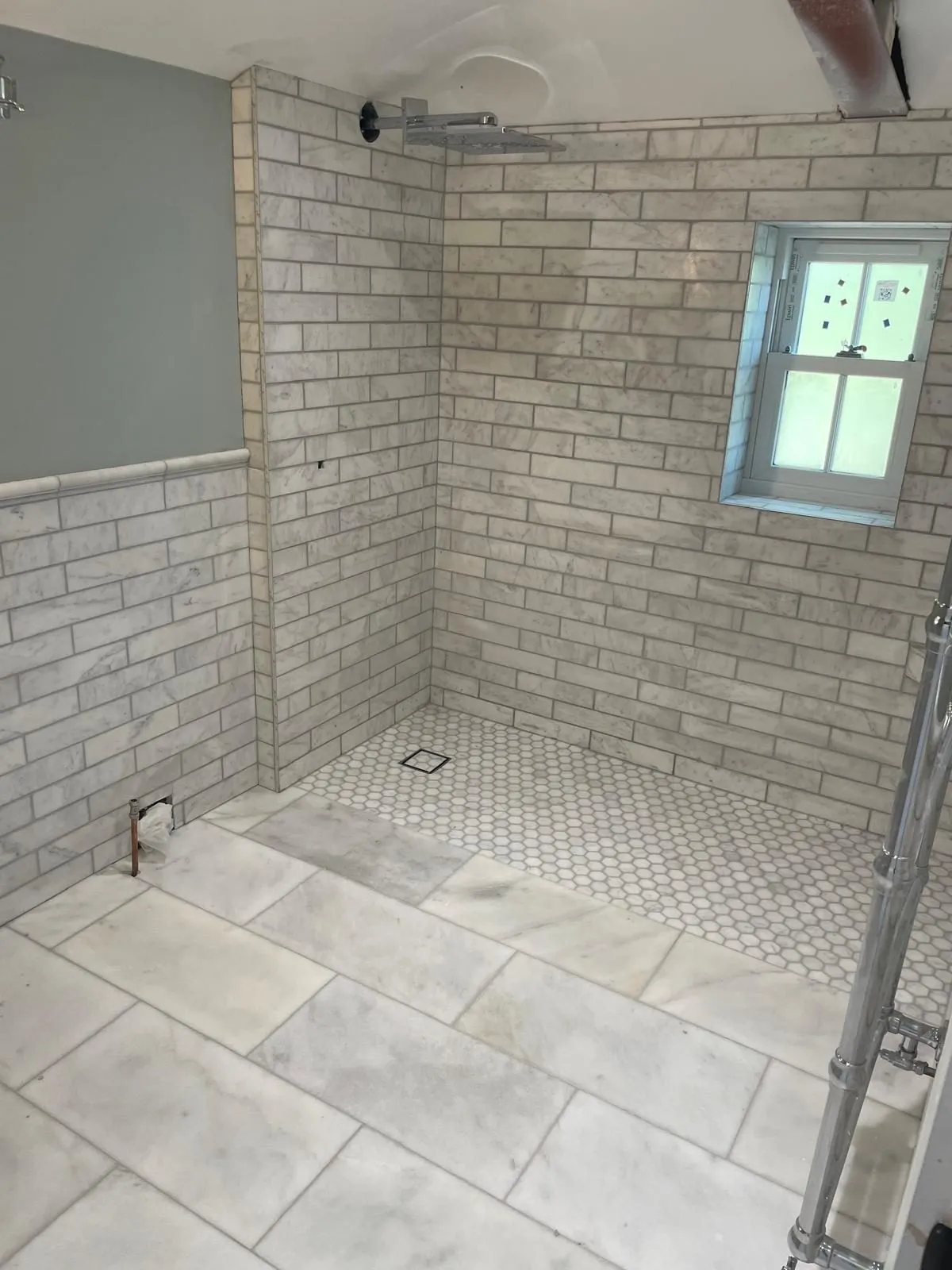 Marble-tiled wet room with mosaic shower floor in Windsor