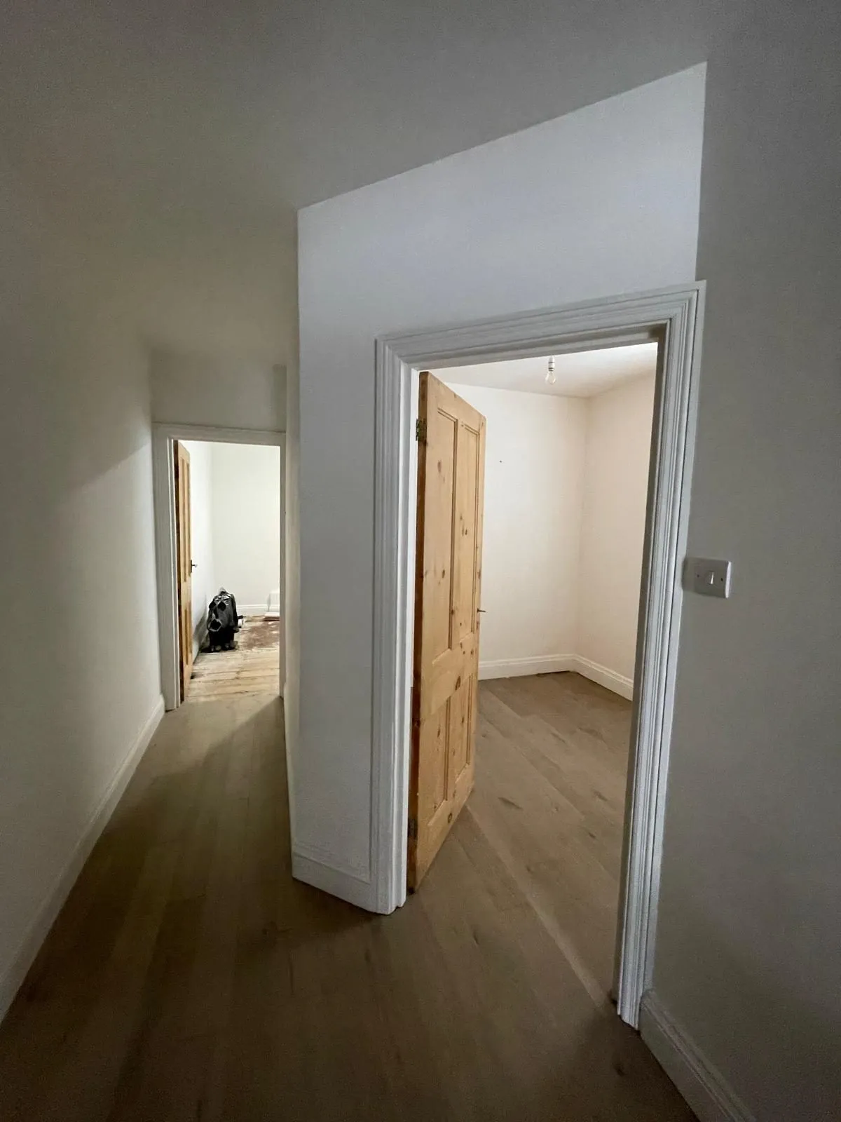 Renovated hallway with wood flooring in Egham