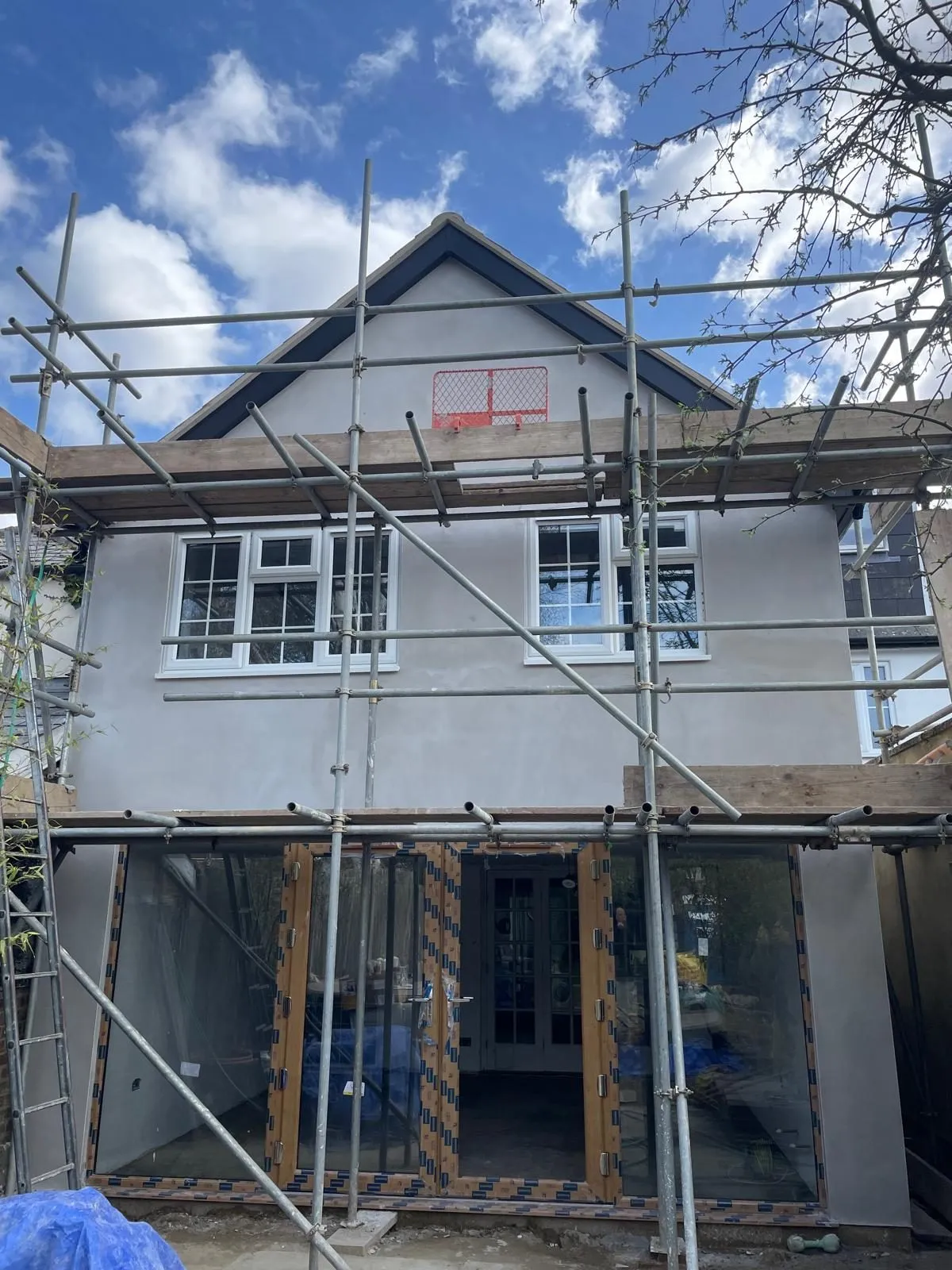 Rendered double-storey extension with large doors, Egham