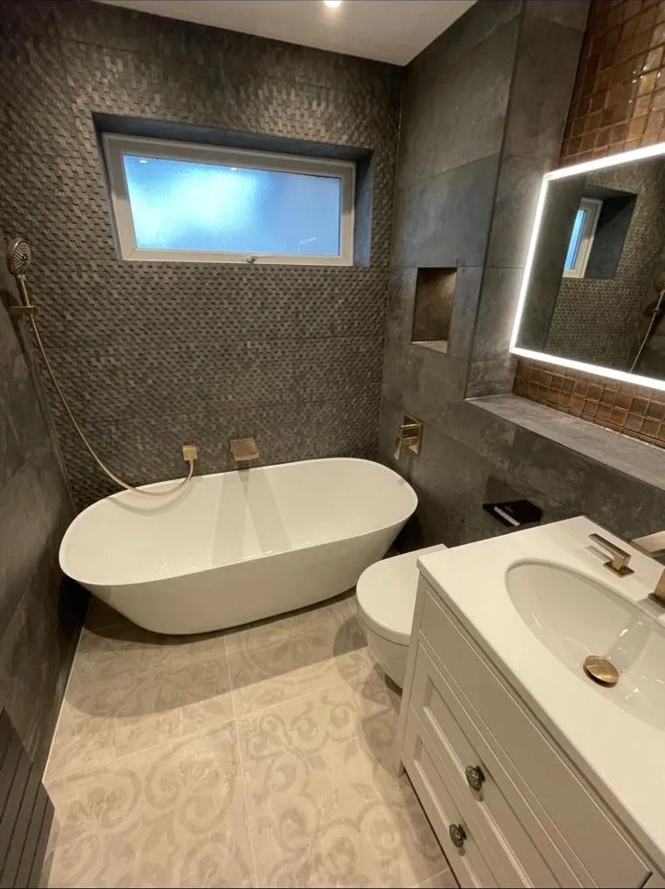 Egham bathroom with freestanding bath and mosaic feature wall