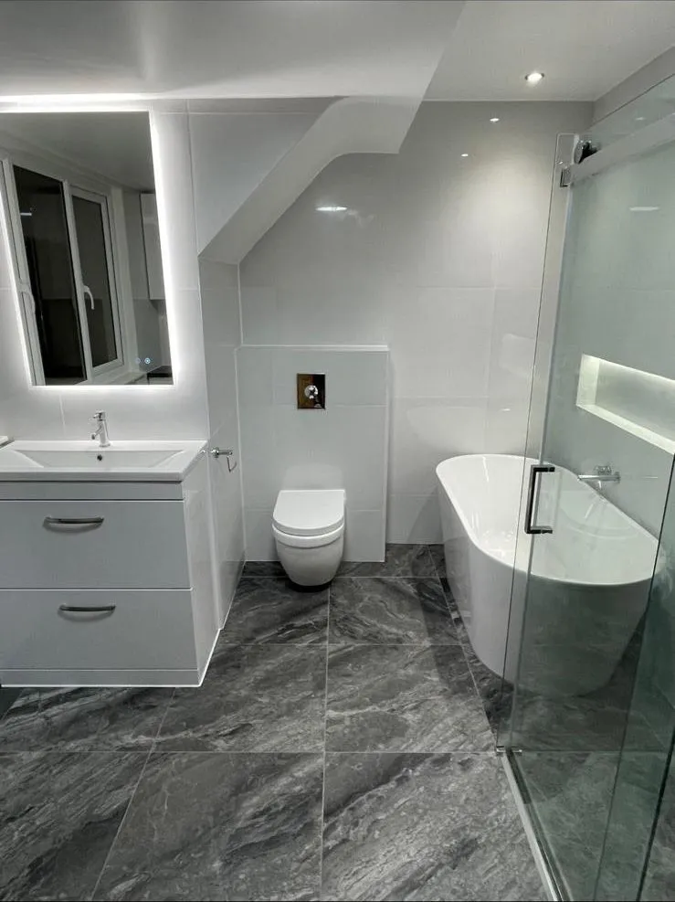 Renovated bathroom with freestanding bath in white and grey, Egham
