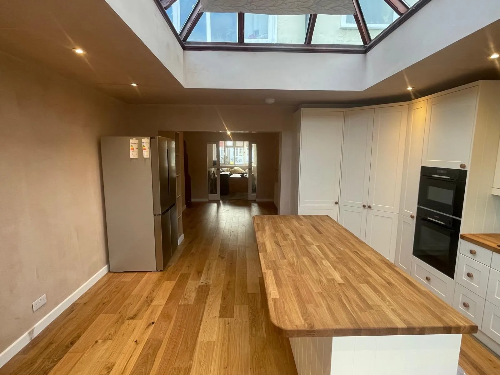 Renovated kitchen diner with island and skylight in Egham